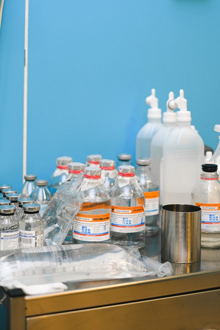 about-01 Selection of medical supplies on a table in a laboratory setting with blue wall.